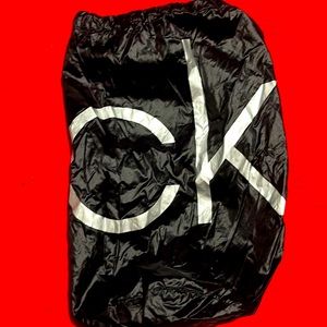 CK black draw string bag, used but great condition. Black and silver 12” x 5”